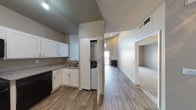 Located at 23643 Newhall Ave in Santa Clarita, California, this single-floor residence offers a thoughtfully designed layout with a neutral color palette and a blend of hardwood-style and carpeted flooring throughout. The open-concept living area is anchored by a fireplace and benefits from vaulted ceilings that lend the space an airy, expansive feel. A sliding glass door provides access to an outdoor area while allowing natural light to brighten the interior.

The kitchen is well-appointed with white shaker-style cabinetry, granite-look countertops, and a full suite of appliances including a stainless steel refrigerator, gas range, built-in microwave, and dishwasher. A conveniently located closet houses a stacked washer and dryer unit, adding in-unit laundry functionality. The hallway connects the main living areas to the bedroom, which features plush carpeting and a large window with vertical blinds that invite natural light and outdoor views. The bathroom includes a clean, white tub-shower combination. The overall ambiance of the space is calm and functional, with a consistent, modern aesthetic suitable for comfortable everyday living.