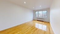 Located at 7211 Avenue Fielding, Unit 301, in Montréal's NDG neighbourhood, this well-appointed 2-bedroom, 1-bathroom unit offers a thoughtfully designed single-floor layout. Polished hardwood flooring flows throughout the living areas and bedrooms, reflecting natural light and adding warmth to the space. The living room is bright and open, featuring a large window with views of the surrounding neighbourhood and a classic radiator for efficient heating. The kitchen is modern and functional, appointed with light wood cabinetry, white countertops, a white tile backsplash, stainless steel appliances including a range hood and refrigerator, and a window overlooking the outdoors. The primary bedroom is generously sized, with recessed lighting and ample room, while the second bedroom offers a comfortable and versatile space. Both bedrooms feature clean white walls and gleaming hardwood floors. The bathroom is a standout feature, fully clad in striking marble-effect tile on both the walls and floors, and equipped with a soaking bathtub, a white vanity, and a frosted window for privacy. A hallway and closet complete the layout, offering practical storage and circulation throughout the unit.