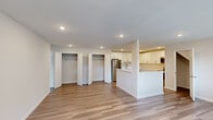 Located at Heatherwood – Lakeside Village in East Patchogue, NY, this single-floor residence offers a clean, contemporary design with a cohesive, light-filled aesthetic throughout. The open-concept living area is finished with smooth hardwood-style flooring and recessed lighting, creating a bright and welcoming atmosphere. Large windows along the front of the home allow natural light to pour in, enhancing the airy feel of the space. The kitchen is thoughtfully designed with crisp white shaker-style cabinetry, ample upper and lower storage, a white countertop peninsula, and a full suite of stainless steel appliances, including a refrigerator, range, microwave, and dishwasher. Adjacent to the main living area, dual closets with bifold doors provide generous storage capacity. The bedrooms are generously sized, with plush carpeting, large windows with outdoor views, and multiple closets — including a walk-in — offering abundant storage. The bathroom features a sleek white vanity with an undermount sink, brushed gold fixtures, and a large frameless mirror, lending a refined, modern touch. Neutral tones and consistent finishes throughout the home create a polished, move-in-ready environment suited for comfortable everyday living.