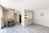 Located at 13011 Northborough Dr in Houston, TX, this one-bedroom, one-bathroom residence offers a thoughtfully arranged single-floor layout that maximizes every square foot. The living room is bright and open, featuring light gray wood-style flooring, neutral-toned walls, and a ceiling fan. A sliding glass door leads to a private balcony, filling the space with natural light and offering an outdoor retreat. The kitchen is efficiently designed with white cabinetry, white quartz-style countertops, a black electric range with overhead ventilation, and a black refrigerator. A pass-through window connects the kitchen to the living and dining area, creating an open and communicative flow between spaces. The dining area is conveniently positioned adjacent to the kitchen, with easy access to the balcony. The bedroom features plush carpeting, neutral walls, and a window that allows natural light in, complemented by two closets for ample storage. The full bathroom is clean and functional, appointed with a tiled shower-tub combination, a vanity with a single sink, and wood-style flooring. A dedicated entrance and pantry further enhance the practicality of this well-appointed Houston residence.