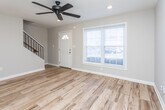 Located in Marietta, GA, this two-story home offers a clean, updated interior with a cohesive design throughout both levels. The main floor welcomes you with warm wood-look plank flooring that extends through the living and entry areas. The front entry is bright and open, anchored by a classic paneled front door with a transom window and a large picture window fitted with white blinds that invite natural light and outdoor views. A ceiling fan with recessed lighting overhead adds a functional, modern touch to the living space.

The kitchen is well-appointed with dark espresso cabinetry, granite countertops, and stainless steel appliances, including a full-size refrigerator. The layout is efficient, providing ample storage and counter space.

Upstairs, the bedrooms are carpeted in a neutral tone and filled with natural light from generously sized windows with white blinds. The rooms are versatile and well-proportioned, offering comfortable living space.

The bathroom is thoughtfully finished with large-format tile in the tub/shower surround, accented by a decorative mosaic tile inset. A dark-framed vanity mirror, granite-topped vanity, and wood-look tile flooring complete the polished look. Throughout the home, neutral wall tones and consistent trim work create a cohesive and move-in-ready atmosphere.
