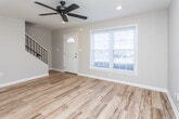 Located in Marietta, GA, this two-story home offers a clean, updated interior with a cohesive design throughout both levels. The main floor welcomes you with warm wood-look plank flooring that extends through the living and entry areas. The front entry is bright and open, anchored by a classic paneled front door with a transom window and a large picture window fitted with white blinds that invite natural light and outdoor views. A ceiling fan with recessed lighting overhead adds a functional, modern touch to the living space.

The kitchen is well-appointed with dark espresso cabinetry, granite countertops, and stainless steel appliances, including a full-size refrigerator. The layout is efficient, providing ample storage and counter space.

Upstairs, the bedrooms are carpeted in a neutral tone and filled with natural light from generously sized windows with white blinds. The rooms are versatile and well-proportioned, offering comfortable living space.

The bathroom is thoughtfully finished with large-format tile in the tub/shower surround, accented by a decorative mosaic tile inset. A dark-framed vanity mirror, granite-topped vanity, and wood-look tile flooring complete the polished look. Throughout the home, neutral wall tones and consistent trim work create a cohesive and move-in-ready atmosphere.