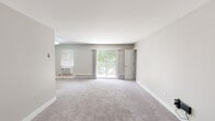 Located at 400 Matawan Ave in Cliffwood, NJ, this single-floor residence offers a well-designed layout with thoughtfully updated finishes throughout. The living areas are generously sized, featuring plush neutral-toned carpeting, clean white baseboards, and soft gray walls that create a calm, cohesive atmosphere. Large sliding glass doors in both the living room and an additional room provide direct access to a private balcony, filling the interior with natural light and offering pleasant views of mature surrounding greenery.

The kitchen stands out with rich, dark wood cabinetry on both upper and lower levels, complemented by sleek silver hardware, crisp white quartz countertops, and a stylish gray subway tile backsplash. Stainless steel appliances complete the modern aesthetic, while wood-look flooring grounds the space practically and visually.

The bedrooms are well-proportioned with soft carpeting and ample closet space, including walk-in and standard closets with built-in rods for organization. Each room benefits from natural light through windows fitted with blinds.

The bathroom is a refined highlight, finished with large-format marble-look tile covering the walls of the tub surround, a built-in niche, and chrome fixtures — lending an elegant, spa-like quality. The overall space presents a clean, move-in-ready environment with modern updates and comfortable, functional design throughout.