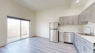 Located at 983 Dewey Ave, Unit 709 in Los Angeles, this thoughtfully designed one-bedroom unit offers a clean, modern aesthetic throughout. The open-concept kitchen and living area is anchored by light wood-style luxury vinyl flooring that extends seamlessly across the space, creating a bright and cohesive feel. The kitchen is well-equipped with stainless steel appliances — including a full-size refrigerator, gas range, dishwasher, and built-in microwave — complemented by grey shaker-style cabinetry and light countertops. A sliding glass door opens to a private balcony, flooding the living area with natural light and providing a connection to the outdoors. The bedroom is generously proportioned and finished with plush carpet, soaring ceilings, and multiple windows fitted with roller shades. These windows frame striking views of the Los Angeles skyline and the surrounding cityscape, making the bedroom a standout feature of the unit. A mirrored closet adds functionality and further enhances the sense of openness. Recessed lighting throughout and crisp white walls contribute to the unit's clean, contemporary character, making this a polished and move-in-ready residence in the heart of Los Angeles.