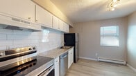 Located at 2979 Columbus St in Grove City, Ohio, this single-floor unit offers a clean, modern aesthetic with thoughtful updates throughout. The kitchen is a standout feature, showcasing white shaker-style cabinetry, granite-style countertops, a classic white subway tile backsplash, and a full suite of stainless steel appliances including an electric range, dishwasher, and refrigerator. A stainless steel sink with a contemporary faucet completes the functional and stylish space.

The living area is bright and open, featuring light-toned luxury vinyl plank flooring and a large window that allows natural light to fill the room. A baseboard heating system is present throughout the unit, ensuring consistent warmth. The bedroom offers plush carpeting, neutral-toned walls, and a window with blinds that provides a comfortable and quiet retreat.

The bathroom is well-appointed with a white vanity featuring a clean countertop, a tiled tub-shower combination, wood-look flooring, and a window for natural ventilation. Additional carpeted spaces provide flexible room options. Throughout the unit, crisp white trim, neutral wall tones, and textured ceilings contribute to a cohesive, move-in ready environment.