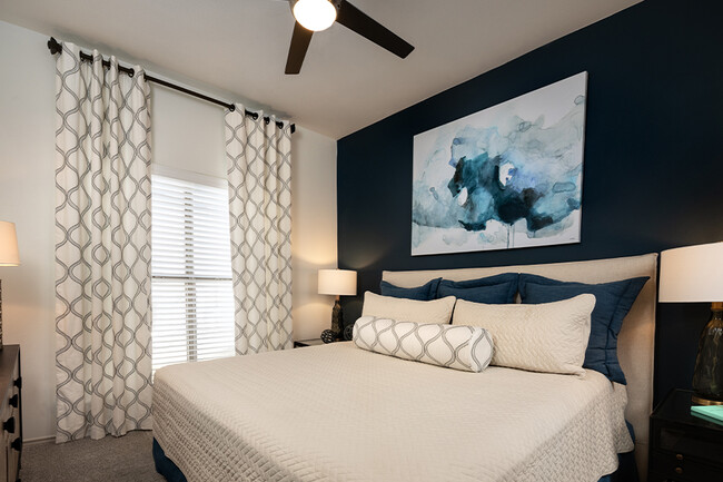 Bedrooms feature upgraded ceiling fans and new carpet - The Madison Apartments