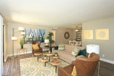 This well-appointed single-floor residence in Albuquerque offers a thoughtfully designed layout that balances comfort and functionality. The open living area is a welcoming centerpiece, featuring wood-look flooring, a textured ceiling, and large sliding glass doors that flood the space with natural light and provide direct access to a landscaped outdoor area through a distinctive arched entryway. The living room flows seamlessly into a dedicated dining area, complete with a ceiling fan overhead.

The galley-style kitchen is outfitted with dark cabinetry, granite-look countertops, a subway tile backsplash, black appliances including a gas range and refrigerator, and a double-basin sink — offering both style and practicality.

The primary bedroom features wood-look flooring, warm neutral tones, and a dedicated closet with built-in shelving. The second bedroom also includes wood-look flooring, a large window with exterior views, and a sliding closet. Both rooms offer a calm, restful atmosphere.

The bathroom is finished with a dark-toned vanity, wood-look flooring, a framed mirror, and a shower-tub combination. Throughout the residence, consistent warm-toned walls and wood-look flooring create a cohesive and inviting aesthetic.