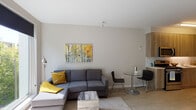 Located on NE Martin Luther King Jr Blvd in Portland's vibrant King neighborhood, this modern one-bedroom unit offers a thoughtfully designed single-floor layout with clean lines and contemporary finishes throughout. The open-concept living and dining area is bathed in natural light from oversized windows that frame lush, leafy outdoor views, creating a bright and welcoming atmosphere. The living space features light wood-tone flooring and neutral walls, providing a versatile backdrop. The kitchen is efficiently designed with warm wood-grain cabinetry extending to the ceiling, a crisp white countertop, white tile backsplash, and a full suite of stainless steel appliances including a gas range, microwave, and dishwasher. The bedroom is a calm retreat with soft neutral tones, a large window with outdoor views, and access to a dedicated walk-in closet. The bathroom features a clean, minimalist design with wood-tone cabinetry, a wide vanity mirror, and a tub-shower combination. An in-unit washer and dryer add everyday convenience. This unit combines modern urban living with a warm, natural aesthetic in one of Portland's well-connected neighborhoods.