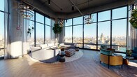 Located in Chicago's vibrant West Town neighborhood, this upscale amenity lounge at 740 N Aberdeen Street offers a refined and thoughtfully designed communal experience. The space is anchored by dramatic floor-to-ceiling curtain-wall glazing that wraps around the perimeter, flooding the interior with abundant natural light and framing sweeping panoramic views of the Chicago skyline and surrounding cityscape.

The main lounge area features herringbone-patterned hardwood flooring throughout, complemented by high exposed ceilings with industrial-style ductwork and bold orbital pendant lighting that adds a contemporary edge. Generously scaled curved sofas, rattan armchairs with teal upholstery, and layered area rugs define distinct seating zones, creating an inviting atmosphere suited for both social gatherings and quiet relaxation.

A dedicated kitchen and bar area showcases custom teal cabinetry with brass hardware, mosaic tile accents, built-in shelving with curated décor, and a large island with bar seating — ideal for casual dining or entertaining. Lush indoor trees and trailing greenery are positioned throughout, adding warmth and a biophilic character to the industrial-modern aesthetic.

Glazed doors open to an outdoor terrace, extending the social space and offering direct access to open-air seating with additional skyline views. The overall ambiance is sophisticated yet approachable, blending urban energy with elevated comfort.
