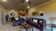 Located at 4415 E 46th St in North Little Rock, Arkansas, this single-floor residence offers a thoughtfully designed layout with a warm, cohesive aesthetic throughout. The open-concept living area serves as the heart of the home, featuring vaulted ceilings with crown molding, a ceiling fan, and recessed lighting that create an inviting atmosphere. Plush carpeting anchors the space, which flows seamlessly from the living room into the dining area and kitchen. A large wall mirror and decorative accents add dimension to the living room.

The galley-style kitchen is well-equipped with rich wood cabinetry, granite-look countertops, stainless steel appliances including a built-in microwave and dishwasher, and tile flooring. A breakfast bar connects the kitchen to the main living space, enhancing the open feel.

The dining area, positioned near the entryway, features tile flooring and offers a functional yet stylish space for meals. The bedroom is spacious and carpeted, with a ceiling fan, natural light from a window with blinds, and direct access to a walk-in closet. The bathroom is finished with full granite-tile surround walls and a soaking tub, delivering a clean and polished look. Throughout the home, neutral tones and consistent finishes create a harmonious and comfortable living environment.
