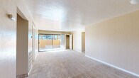 Located at 7001 E Golf Links Rd in Tucson, Arizona, this single-floor, 3-bedroom, 2-bathroom home offers a practical and comfortable layout. The living room is generously proportioned, featuring plush carpeting, a textured ceiling, and a sliding glass door that opens to an outdoor area, allowing natural light to fill the space while providing views of the surrounding desert landscape.

The galley-style kitchen is well-appointed with warm wood cabinetry, granite-style countertops, tile flooring, and a stainless steel sink. A sliding glass door at the end of the kitchen offers additional outdoor access and natural light.

The three carpeted bedrooms are comfortably sized. The primary bedroom is notably spacious, with access to a closet and its own doorway connecting to a hallway. Additional bedrooms feature neutral tones, carpet flooring, and windows that bring in natural light. One bedroom includes a mirrored sliding closet door, enhancing the sense of space.

Both bathrooms are finished with tile flooring and warm wood vanities with granite-style countertops. One bathroom features a tiled shower-tub surround with a decorative mosaic accent border, while the second offers a clean, functional shower-tub combination. A connecting hallway ties the bedrooms and bathrooms together, completing this efficiently designed home.