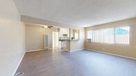 Located on Alondra Blvd in Norwalk, CA, this thoughtfully laid-out one-bedroom, one-bathroom unit offers a comfortable and efficient use of space across a single floor. The open-concept living and dining area provides a welcoming atmosphere, finished with durable wood-style flooring and neutral warm-toned walls that lend a bright, cohesive feel throughout. A textured ceiling and ceiling fan add character to the main living space, which receives natural light through large windows dressed with vertical blinds. The kitchen is well-appointed with white cabinetry, dark countertops, a gas range, and a peninsula-style breakfast bar that connects seamlessly to the dining area — ideal for casual entertaining. A wall-mounted A/C unit in the dining area ensures year-round comfort. The bedroom is a comfortable retreat featuring a ceiling fan, a natural light-filled window, mirrored sliding closet doors, and additional overhead cabinetry for generous storage. The bathroom is clean and functional, featuring a full tiled tub-shower combination with chrome fixtures and a window for ventilation. Two closets and a dedicated hallway provide practical storage and easy flow between rooms, completing this well-organized and move-in-ready unit.