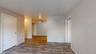 Located at 3751 S 700 W in South Salt Lake, Utah, this single-floor unit offers a practical and well-appointed layout designed for comfortable everyday living. The main living and dining areas are finished with durable wood-look flooring and neutral-toned walls, creating a clean, cohesive aesthetic throughout. A ceiling fan overhead adds function to the open living space, which flows naturally into the dining area and beyond.

The kitchen is outfitted with crisp white shaker-style cabinetry, light countertops, and a full suite of appliances including an electric range and refrigerator. Light-toned flooring and recessed lighting give the kitchen a bright, modern feel. A dedicated laundry area with hookups and built-in shelving provides convenient in-unit utility storage.

The bedrooms are carpeted for comfort and feature sliding-door closets with shelving, as well as windows that allow natural light to filter in. The full bathroom includes a white vanity with a single sink, gray countertop, under-sink cabinetry, a large mirror, and a tiled shower-tub combination. Wood-look flooring in the bathroom ties the space together with the rest of the unit.

The entry area welcomes residents with wood-look flooring and a large window, providing a bright and inviting first impression. Overall, the unit presents a clean, updated interior with a neutral palette throughout.