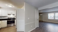 Located at 8 Osterville Ct in Yarmouth, Maine, this two-floor home offers a clean, updated interior designed for comfortable everyday living. The main level features a welcoming entryway with natural light filtering through sidelight windows, opening into a spacious living area with durable hardwood-style flooring and a large window overlooking the outdoors. Sliding glass doors connect the dining area to exterior views, filling the space with light. The kitchen is well-appointed with crisp white shaker-style cabinetry, dark granite countertops, a stainless steel sink, and a full suite of stainless steel appliances including an electric range with overhead ventilation and a dishwasher. A half bathroom on the main level provides added convenience, featuring a wall-mounted sink and mirrored medicine cabinet. A staircase leads to the upper floor, where carpeted bedrooms offer a quiet retreat. One bedroom features a generous closet with double sliding doors, while another provides a wide window with natural light and baseboard heating. The full bathroom upstairs includes a tub/shower combination with a window for ventilation. Throughout the home, neutral tones, textured ceilings, and consistent trim details create a cohesive and move-in-ready environment.