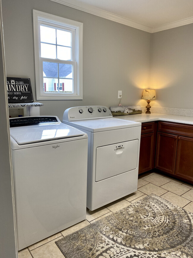 Large laundry room with HE washer and dryer. - 127 W Young St.