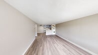 Located in the Clairemont neighborhood of San Diego, this well-appointed 1-bedroom, 1-bathroom unit offers a thoughtfully designed layout across a single floor. The open-concept living area is bright and welcoming, featuring light wood-style vinyl plank flooring, neutral warm-gray walls, and a textured ceiling. A ceiling fan adds comfort, while a large window frames outdoor greenery and fills the space with natural light. A built-in shelving unit provides functional display and storage space, seamlessly connecting the living area to the kitchen.

The kitchen is accessible via a peninsula-style pass-through, complete with gray cabinetry, stainless steel appliances, and a clean white countertop. The layout encourages an easy flow between cooking and living spaces.

The generously sized bedroom is carpeted for warmth and comfort, featuring neutral gray walls and a window with outdoor views, allowing natural light to filter in throughout the day.

The bathroom has been updated with crisp white shaker-style cabinetry, a white quartz countertop, a single undermount sink with matte black fixtures, and a full tub-shower combination. Clean lines and neutral tones give it a modern, polished feel.

The unit also includes a closet, hallway, and dedicated entry area, rounding out a complete and functional living space.