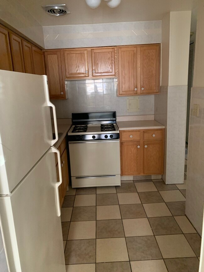 ceramic tiled Kitchen with oak cabinets - 2000 W Summerdale Ave
