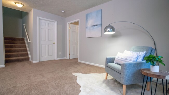Revel in generously-sized living rooms with plush carpeting. - The Reserve at Monroe Crossings