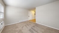 This 470 square foot apartment in Downingtown, PA offers a thoughtfully designed living space on a single floor. The layout comprises a living room, one bedroom measuring 140 square feet, and one bathroom. The apartment showcases a blend of modern finishes and practical design elements.

The living area features plush carpeting, creating a cozy atmosphere. Large windows throughout allow for ample natural light, brightening the space and providing views of the surrounding area. The kitchen, while compact, is efficiently designed with updated appliances and ample counter space for meal preparation.

The bedroom, at 140 square feet, offers sufficient space for a comfortable sleeping area. It includes carpeting, a window for natural light, and a ceiling-mounted light fixture. The bathroom appears to have been recently updated, featuring a white tub-shower combination with built-in shelving for added convenience.

Throughout the apartment, neutral-toned walls create a clean, fresh backdrop that can easily accommodate various decor styles. Baseboard heating units are strategically placed for efficient climate control. The apartment's layout maximizes the use of its 470 square feet, creating a functional and inviting living space ideal for individuals or couples seeking a cozy home in Downingtown.