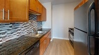 Located at 110 North 17th Street in St. Louis, Missouri, this one-bedroom, one-bathroom unit offers a thoughtfully designed layout across a single floor. Light-toned hardwood flooring flows consistently throughout, lending a clean and cohesive look to every room.

The combined kitchen and living area serves as the heart of the unit. The living space is bright and open, featuring large windows that invite natural light and offer views of the surrounding cityscape, along with a wall-mounted HVAC unit for climate control. The kitchen is well-equipped, showcasing warm wood cabinetry, dark granite countertops, a decorative mosaic tile backsplash, stainless steel appliances, and ample storage — a practical yet stylish space for cooking and entertaining.

The bedroom is generously proportioned, providing comfortable living space with a full-wall closet featuring bi-fold doors for excellent storage. Neutral wall tones and continued hardwood flooring keep the room feeling calm and versatile.

The bathroom is efficiently designed, featuring warm tile flooring, a pedestal sink, a mirrored vanity with overhead lighting, overhead wood cabinetry, and a walk-in shower. Neutral tones throughout the unit create a clean, modern ambiance well-suited for urban living in the heart of St. Louis.
