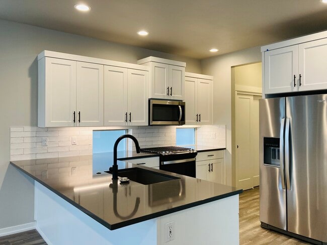 Spacious open-concept kitchen includes all stainless steel appliances, large island, and pantry - 8150 SE Reddington St