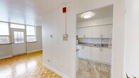 Located at 14 Dublin St in Markham, Ontario, this well-appointed one-bedroom, one-bathroom unit offers a thoughtfully organized single-floor layout. The open living and dining area is defined by warm, light-toned parquet hardwood flooring arranged in a classic basket-weave pattern, creating a timeless aesthetic throughout the main living spaces. Natural light filters in through a window, adding brightness to the generously sized living area.

The kitchen is a dedicated separate space featuring white cabinetry with brushed nickel hardware, granite-patterned countertops, a stainless steel sink, and a white electric range. Stone-look tile flooring in the kitchen provides a clean contrast to the parquet found in the adjoining rooms.

The bedroom offers a comfortable footprint with the same parquet flooring, a large sliding-door closet, and a window with exterior views, providing both storage and natural light. The space is finished with neutral walls, lending itself to easy personalization.

The full bathroom is finished with white subway tile surrounding the bathtub and shower, complemented by a vanity with white cabinetry, gold-toned hardware, and the same stone-look tile flooring as the kitchen. The overall aesthetic of the unit is clean, neutral, and move-in ready, with consistent finishes throughout.