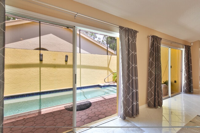 Walk out to pool/screen lanai from living area - 4700 Tivoli Ave