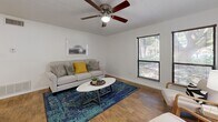 Located at 3424 Frankford Ave in Lubbock, TX, this three-bedroom, one-bathroom unit offers a practical and well-organized single-floor layout. The living room welcomes you with warm wood-style flooring, a ceiling fan, and a window that lets in natural light, creating a bright and comfortable common area. The adjacent kitchen is equipped with warm-toned wooden cabinetry, white appliances including a range, dishwasher, and refrigerator, complemented by tile flooring and a ceiling fan. A dining area sits conveniently alongside the kitchen. The primary bedroom features plush carpeting, a ceiling fan, a window with outdoor views, and access to a spacious walk-in closet outfitted with built-in shelving and hanging rods. The two additional bedrooms are similarly carpeted, each with a ceiling fan and ample closet space. The shared bathroom includes a wood-toned vanity with storage cabinetry, a framed mirror, tile flooring, and a shower-tub combination. Throughout the unit, white walls and consistent finishes create a clean, cohesive aesthetic. Ceiling fans in every room ensure year-round comfort, making this a functional and well-appointed home.