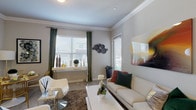 This single-story residence offers a thoughtfully designed layout across one bedroom and one bathroom. The living area is bright and welcoming, featuring crown molding, wood-style flooring, and multiple windows dressed with blinds and green drape panels that invite natural light. A dedicated dining nook adjacent to the living space provides a cozy area for meals, accented by neutral walls and hard surface flooring.

The kitchen is well-equipped with dark espresso cabinetry extending to the ceiling, granite countertops, a tile backsplash, and a full suite of stainless steel appliances including a refrigerator, range, microwave, and dishwasher. A peninsula with a double-basin sink adds prep space and a pendant light overhead enhances functionality.

The bedroom is carpeted and features crown molding, a large window with ample natural light, and generous wall space. The bathroom complements the kitchen's aesthetic with matching dark cabinetry, granite countertops, a large soaking tub with full tile surround, and wood-style flooring. Throughout the residence, neutral tones and consistent finishes create a cohesive and polished living environment.
