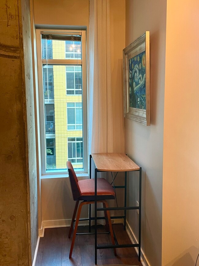 Living room includes a built in desk and this nook, which could also serve as a workspace. - 1700 Bassett St
