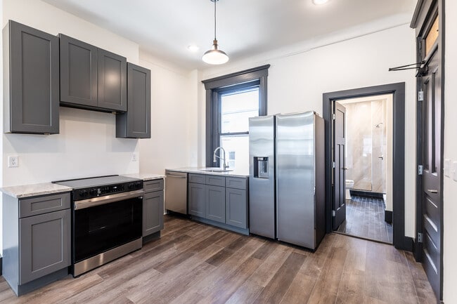 Kitchen with all new appliances, Microwave/hood has been installed. - 728 E McMillan St