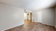 This single-floor residence offers a practical and comfortable layout designed for everyday living. The main living area features warm wood-look flooring and a neutral color palette, creating a clean and inviting atmosphere. A textured ceiling adds subtle character throughout the space, while ample wall outlets and HVAC vents ensure functional comfort. The living area flows seamlessly into the kitchen, which is equipped with dark espresso-toned cabinetry, light countertops, a built-in dishwasher, and a double sink — offering a functional workspace with ample storage. The bedrooms are carpeted for comfort and each features a ceiling fan with integrated lighting, a window allowing natural light and outdoor views, and a dedicated closet with shelving for organized storage. The full bathroom includes a tiled shower-tub combination, a dark-cabinetry vanity with a single sink, a large mirror, and a well-lit vanity light bar. The 3D floorplan reveals a well-proportioned layout with clearly defined living, cooking, sleeping, and bathing zones. Overall, the space presents a clean, move-in-ready environment with consistent finishes throughout.