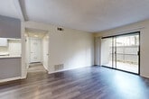 Located at 1251 Massachusetts Ave in Riverside, CA, this single-floor 1-bedroom, 1-bathroom residence offers a well-organized layout across a comfortable footprint. The interior is unified by durable wood-look flooring that runs throughout the main living areas, complementing the neutral, light-toned walls and textured ceilings.

The living room is bright and open, highlighted by a sliding glass door that provides direct access to a private patio and fills the space with natural light. Adjacent to the living area, the dining room flows seamlessly toward the kitchen, which features gray shaker-style cabinetry, white quartz countertops, stainless steel appliances including a gas range and dishwasher, and a stainless steel sink — offering both style and functionality.

A ceiling fan in the dining area adds comfort, while the hallway connects the main living spaces to the bedroom and bathroom. The bedroom is generously sized, equipped with a sliding closet, a large window that allows ample natural light, and direct access to the hallway. The bathroom is clean and modern, appointed with a gray vanity, white countertop, and well-lit mirror.

Additional utility rooms and closets throughout provide practical storage. The patio, framed by mature landscaping, adds an inviting outdoor extension to this well-appointed residence.