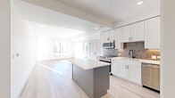 Located at 1050 W Hampden Ave in Englewood, CO, this thoughtfully designed single-floor home offers four bedrooms, three bathrooms, and a well-appointed layout that maximizes comfort and functionality. The open-concept kitchen and living area serves as the heart of the home, featuring white shaker cabinetry with matte black hardware, a gray center island with a quartz countertop, a stylish tile backsplash, and stainless steel appliances. Light wood-look flooring flows seamlessly throughout, enhancing the bright and airy atmosphere created by recessed lighting and large windows. The living area connects to an outdoor space via a glass-panel door, allowing natural light to pour in. Each bedroom is generously sized, with ceiling fans, large windows offering outdoor views, and dedicated closets for ample storage. The primary bedroom features an en-suite bathroom with a double-sink vanity, white cabinetry, and a glass-enclosed walk-in shower with large-format tile. Additional bathrooms are finished with clean white vanities, tile flooring, and modern matte black fixtures. The home's cohesive modern aesthetic, bright neutral palette, and quality finishes make it a polished and welcoming residence in the Englewood community.
