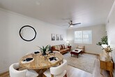 Located at 4111 N Drinkwater Blvd in Scottsdale, Arizona, this single-story, one-bedroom, one-bathroom residence offers a thoughtfully designed open-concept layout with clean, modern finishes throughout. Light wood-style flooring flows seamlessly across the entire space, complemented by crisp white walls and crown molding that lend a polished, cohesive aesthetic.

The combined kitchen and living area forms the heart of the home. The kitchen features a white peninsula with a quartz countertop, undermount sink, white shaker cabinetry, stainless steel appliances, and stylish pendant lighting overhead. A galley-style layout provides ample counter and storage space. The dining area sits adjacent to the kitchen, while the living room benefits from large windows that invite abundant natural light and a ceiling fan for year-round comfort.

The bedroom is a serene retreat, offering a comfortable footprint, a ceiling fan, a window with natural light, and multiple closets for generous storage. The full bathroom is clean and functional, featuring white cabinetry with quartz countertops, a tub-shower combination, and wood-style flooring that ties the space together.

A hallway connects the private areas of the home, and built-in shelving near the entryway adds a practical decorative touch. The overall ambiance is bright, modern, and inviting — ideal for comfortable Scottsdale living.