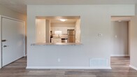 Located at 510 Yorkshire St in Salem, Virginia, this 2-bedroom, 1-bathroom home delivers a clean, modern aesthetic across a single, efficiently designed floor. Wood-look luxury vinyl plank flooring runs throughout the entire residence, providing a cohesive and low-maintenance foundation in every room.

The kitchen is a standout feature, outfitted with white shaker-style cabinetry, granite-look countertops, a classic white tile backsplash, and a full suite of stainless steel appliances including a refrigerator, electric range, and dishwasher. A pass-through window with a granite-look ledge connects the kitchen to the living area, creating an open and communicative layout ideal for everyday living.

The spacious primary bedroom features two windows that invite natural light and is complemented by a large louvered bi-fold closet. The second bedroom also benefits from natural light through a single window and includes a dedicated closet with shelving. Both rooms carry the same neutral, warm tones found throughout the home.

The bathroom is neatly finished with a full tub-shower combo, a white vanity with brushed nickel hardware, and wood-look flooring. Additional storage is provided by four closets distributed throughout the unit. Hallways connect the rooms with ease, rounding out a well-organized and move-in ready home.