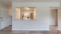 Located at 510 Yorkshire St in Salem, Virginia, this 2-bedroom, 1-bathroom home delivers a clean, modern aesthetic across a single, efficiently designed floor. Wood-look luxury vinyl plank flooring runs throughout the entire residence, providing a cohesive and low-maintenance foundation in every room.

The kitchen is a standout feature, outfitted with white shaker-style cabinetry, granite-look countertops, a classic white tile backsplash, and a full suite of stainless steel appliances including a refrigerator, electric range, and dishwasher. A pass-through window with a granite-look ledge connects the kitchen to the living area, creating an open and communicative layout ideal for everyday living.

The spacious primary bedroom features two windows that invite natural light and is complemented by a large louvered bi-fold closet. The second bedroom also benefits from natural light through a single window and includes a dedicated closet with shelving. Both rooms carry the same neutral, warm tones found throughout the home.

The bathroom is neatly finished with a full tub-shower combo, a white vanity with brushed nickel hardware, and wood-look flooring. Additional storage is provided by four closets distributed throughout the unit. Hallways connect the rooms with ease, rounding out a well-organized and move-in ready home.