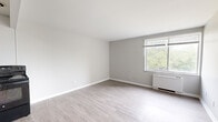 Located at 1673 Cedar Ave in Cincinnati, Ohio, this one-bedroom, one-bathroom residence offers a thoughtfully organized single-floor layout that maximizes every inch of its compact footprint. The living room serves as the heart of the home, featuring light-toned laminate flooring, neutral gray walls, and a large window that fills the space with natural light and offers pleasant views of surrounding greenery. A baseboard heating unit ensures year-round comfort. The kitchen is appointed with gray cabinetry, light countertops, and a stainless steel refrigerator, presenting a modern and functional workspace. The bedroom is a well-proportioned retreat with the same consistent flooring and neutral tones, complemented by a dedicated closet for ample storage. A hallway connects the rooms efficiently, contributing to the home's practical flow. The bathroom features a full tub-shower combination with white tile surround and chrome fixtures, maintaining the clean, understated aesthetic found throughout the residence. Crisp white trim and baseboards tie each room together, creating a cohesive and move-in-ready interior well-suited for comfortable everyday living.