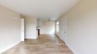 Located at 2800 Braden Ave in Modesto, CA, this single-story one-bedroom, one-bathroom unit offers a well-organized layout across a compact yet functional floor plan. Light-toned, wood-style flooring runs throughout the interior, lending a clean and cohesive aesthetic to every room.

The open living area is bright and airy, benefiting from natural light through a front-facing window and complemented by a ceiling fan overhead. The space flows seamlessly into the galley-style kitchen, which features crisp white shaker cabinetry extending to the ceiling, light quartz countertops, a stainless steel sink, and stainless steel appliances including a gas range, microwave, and dishwasher.

A hallway connects the main living area to the private bedroom, which offers a comfortable and quiet retreat with warm neutral walls and access to a dedicated closet. The full bathroom includes a tub/shower combination, toilet, and a small window for ventilation and natural light.

A standout feature of this unit is the private outdoor deck, which overlooks a landscaped communal green space shaded by mature trees — providing a pleasant outdoor retreat. The overall interior palette of soft neutrals and white trim creates a clean, move-in-ready environment throughout.