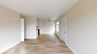 Located at 2800 Braden Ave in Modesto, CA, this single-story one-bedroom, one-bathroom unit offers a well-organized layout across a compact yet functional floor plan. Light-toned, wood-style flooring runs throughout the interior, lending a clean and cohesive aesthetic to every room.

The open living area is bright and airy, benefiting from natural light through a front-facing window and complemented by a ceiling fan overhead. The space flows seamlessly into the galley-style kitchen, which features crisp white shaker cabinetry extending to the ceiling, light quartz countertops, a stainless steel sink, and stainless steel appliances including a gas range, microwave, and dishwasher.

A hallway connects the main living area to the private bedroom, which offers a comfortable and quiet retreat with warm neutral walls and access to a dedicated closet. The full bathroom includes a tub/shower combination, toilet, and a small window for ventilation and natural light.

A standout feature of this unit is the private outdoor deck, which overlooks a landscaped communal green space shaded by mature trees — providing a pleasant outdoor retreat. The overall interior palette of soft neutrals and white trim creates a clean, move-in-ready environment throughout.