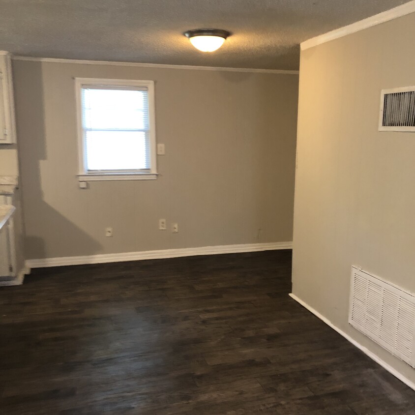 Open living room/ dining room. New flooring throughout. Upstairs screen porch. - 4811 N Main St