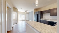 Located on S Tyler Ave in Loveland, Colorado, this well-appointed one-bedroom, one-bathroom unit offers a thoughtfully designed single-level layout. The open-concept kitchen is a standout feature, showcasing rich dark cabinetry, light granite-style countertops, a tile backsplash, and black appliances including a refrigerator, range, microwave, and dishwasher. A peninsula counter extends into the living area, providing additional workspace and a natural division between the two spaces.

The living room is bright and welcoming, with warm hardwood-style flooring, a ceiling fan, and French doors that invite natural light and provide outdoor access. Neutral-toned walls throughout create a clean, cohesive aesthetic.

The bedroom is carpeted for comfort, features a ceiling fan, and is served by a dedicated closet. The bathroom is accessed via a hallway and includes a dark-cabinetry vanity with a granite-style countertop, a large mirror, and hardwood-style flooring that continues the design language of the main living areas.

The unit's efficient use of space, consistent finishes, and practical layout make it a comfortable and functional residence in the Loveland, CO area.
