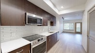 Located at 3111 S St in Sacramento's desirable Curtis Park neighborhood, this efficiently designed single-floor unit offers a thoughtfully laid-out living space with modern finishes throughout. The open-concept layout seamlessly connects the kitchen and living area, maximizing functionality and flow.

The kitchen is a standout feature, showcasing rich dark espresso cabinetry that extends floor to ceiling, providing ample storage. Crisp white quartz countertops contrast beautifully with the cabinetry, while a classic white subway tile backsplash adds texture and style. A full suite of stainless steel appliances — including a refrigerator, electric range, over-the-range microwave, and dishwasher — complete this well-appointed cooking space.

The living area is bright and inviting, featuring light wood-tone flooring that runs throughout the unit, white walls, and a sliding glass door paired with a large window that ushers in abundant natural light and provides access to an outdoor area. Track lighting adds a modern touch overhead.

The bathroom is clean and functional, featuring matching dark wood vanity cabinetry, a white countertop, a large mirror, and accessibility grab bars. Light tile flooring ties the space together cohesively. A dedicated closet rounds out this well-designed unit.