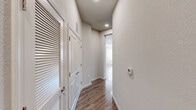 Located at 16 Retriever Trail in Fredericksburg, VA, this single-floor, 4-bedroom, 2-bathroom home offers a thoughtfully designed layout with modern finishes throughout. The open kitchen and living area serves as the heart of the home, featuring rich dark cabinetry, stainless steel appliances including a refrigerator, range, microwave, and dishwasher, light countertops, and a classic mosaic tile backsplash. Hardwood-style flooring runs through the main living areas, complemented by abundant natural light streaming through multiple windows dressed with horizontal blinds. The spacious living room includes a ceiling fan and generous wall space, creating a bright and airy atmosphere. Four well-sized bedrooms offer plush carpeting and ceiling fans, with windows providing natural light and outdoor views. The primary bedroom features a walk-in closet outfitted with wire shelving for ample storage. Both bathrooms are finished with clean, neutral tile and brushed nickel fixtures, including a tub-shower combo. A central hallway connects the rooms efficiently, with recessed lighting and a programmable thermostat adding to the home's practical appeal. Two closets provide additional storage throughout the unit.
