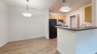 This single-story residence at 1608 Johnson Rd in Petersburg, Virginia offers a well-organized layout designed for comfortable, everyday living. The interior is finished with a neutral color palette throughout, creating a bright and clean aesthetic across all rooms.

The kitchen is a functional galley-style space featuring light wood cabinetry, dark granite-style countertops, a double sink, and black appliances including a refrigerator, gas range, and dishwasher. A pantry closet provides additional storage. The kitchen opens to a dining area highlighted by a pendant light fixture, with wood-look luxury vinyl plank flooring extending through the main living areas.

The living room is generously sized, featuring carpet flooring and glass French doors that allow natural light to fill the space while providing outdoor access. The bedrooms are carpeted and include closet storage, with windows dressed in horizontal blinds.

Two full bathrooms serve the residence, each featuring warm wood-tone vanity cabinetry, white countertops, a tub-shower combination, and wood-look vinyl plank flooring. The layout, as shown in the floor plan, efficiently connects all spaces in a cohesive single-level design suited for practical, comfortable living.
