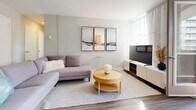 Located at 58 Wellesley St E in the heart of Toronto, this well-appointed one-bedroom, one-bathroom unit offers a smart and functional layout across a single floor. The open-concept living room is bathed in natural light from large floor-to-ceiling windows, with sheer curtains that soften the brightness while maintaining an airy, welcoming atmosphere. Wood-look flooring runs throughout, lending warmth and visual continuity across the space. A glass door opens directly onto a private balcony, offering views of Toronto's dynamic midtown skyline and greenery below — a standout feature of the living area. The kitchen is efficiently designed with white cabinetry, a tile backsplash, ample counter space, and a full suite of stainless steel appliances including a refrigerator, dishwasher, and built-in microwave. The bedroom is a calm, light-filled retreat featuring multiple windows with city views, a built-in closet, and a neutral colour palette that promotes restfulness. A hallway connects the bedroom to the rest of the unit, offering a sense of separation and privacy. The bathroom is finished with clean white subway-style tiles, a soaking tub, and a window that provides natural ventilation. The overall aesthetic is modern and understated, with a cohesive neutral palette throughout.