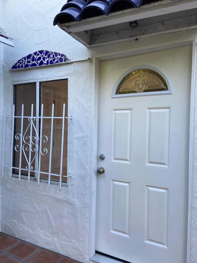 Cobalt Barrel Tiles over Front Door, Blue Mosaic Tiles over Front Window. Charming! - 2107 Vine St