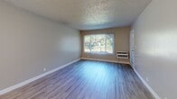 Located at 1390 Creekside Dr in Walnut Creek, California, this one-bedroom, one-bathroom unit offers a well-designed single-floor layout with a functional and comfortable living space. Wood-style flooring runs throughout the unit, lending a clean, cohesive look from room to room.

The kitchen is a standout feature, outfitted with white shaker cabinets, granite countertops, a stainless steel refrigerator, electric range, and dishwasher. A peninsula countertop opens directly into the combined dining and living area, creating an open, connected feel ideal for everyday living and entertaining. The living room receives natural light through a large window with views of surrounding greenery, and includes a ceiling fan for added comfort.

The bedroom is a generous size, featuring a sliding-door closet, hardwood-style flooring, and a window overlooking lush outdoor scenery. The bathroom is well-appointed with a white vanity, full tub/shower combo, and modern fixtures. Additional conveniences include an in-unit laundry area, a hallway connecting the main spaces, and a private patio. The unit also includes wall-mounted HVAC units in the living and bedroom areas.