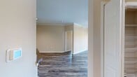 This contemporary 1000 square foot apartment, located in Andover Place at Cross Creek (unit 1B-104), offers a harmonious blend of comfort and style. The two-bedroom, two-bathroom layout maximizes space efficiency, with the primary bedroom boasting a generous 170 square feet. Throughout the apartment, wood-look flooring adds warmth and durability.

The heart of the home is an open-concept kitchen and living area, featuring sleek white cabinetry, stainless steel appliances, and a practical breakfast bar. Large windows in the living space flood the area with natural light and provide scenic views.

Both bedrooms are well-proportioned, with the second bedroom offering flexibility as a guest room or home office. The bathrooms are modern and functional, with one showcasing a combination shower/tub.

Storage is ample, with walk-in closets in both bedrooms and additional hallway storage. The apartment's neutral color palette provides a blank canvas for personal style. Ceiling fans in the bedrooms and living area ensure comfortable air circulation.

This single-floor residence combines practicality with contemporary design, making it an ideal home for those seeking a modern living experience in a well-planned community setting.