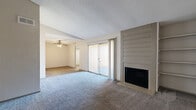This single-story, 3-bedroom, 2-bathroom home in Dallas, Texas offers a practical and comfortable layout across a well-utilized floor plan. The spacious living room serves as the heart of the home, featuring plush carpeting, a wood-burning fireplace flanked by built-in shelving, and a sliding glass door that fills the space with natural light and provides access to an outdoor area. A ceiling fan adds comfort to the adjacent dining or sitting area, which features wood-look flooring for easy maintenance.

The kitchen is equipped with dark cabinetry, light countertops, a white electric range, built-in microwave, dishwasher, and a dedicated pantry with open shelving — offering ample storage for everyday living. Textured ceilings are present throughout the home, lending a classic architectural character.

The three bedrooms are carpeted and well-lit, with the primary bedroom offering generous proportions and a walk-in closet featuring dual hanging rods and built-in shelving. Additional closets throughout the home provide abundant storage. The bathrooms include a tub-shower combination with clean white tile surrounds and chrome fixtures. Two hallways connect the living spaces efficiently, making the overall flow of the home logical and easy to navigate.